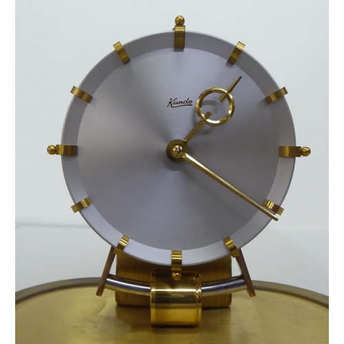 318 - A Kundo Electromagnetic mantel clock; the exposed movement faced by a baton dial  9