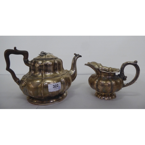 322 - A late 19thC Continental white metal teapot and milk jug of pedestal, ribbed design