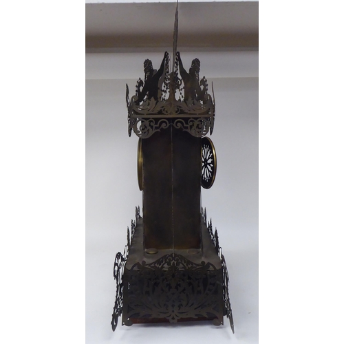 335 - A Continental fretworked brass cased mantel clock, featuring nude term figures, heraldic lions, flor... 