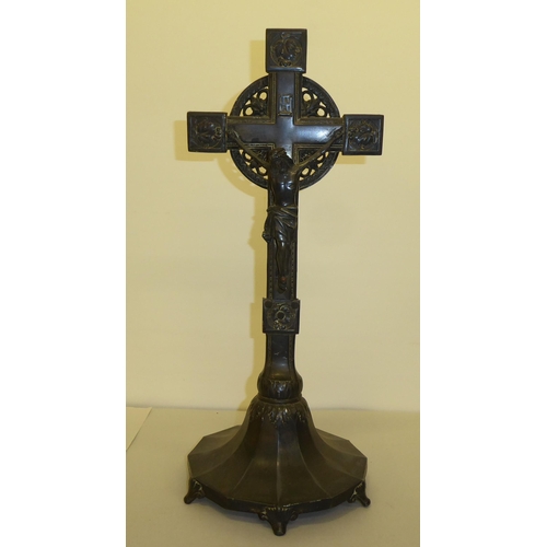 346 - A cast metal freestanding crucifix, decorated with floral designs and bearing the inscription INRI&n... 