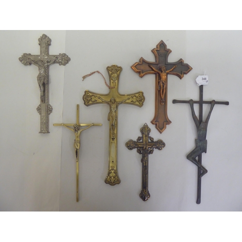 348 - Six cast metal crucifixes  varying designs & sizes  largest 16