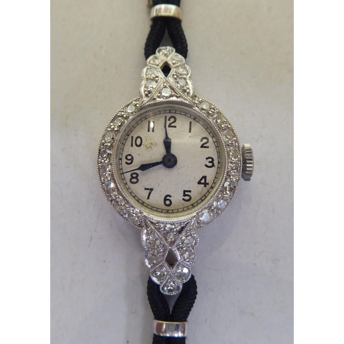 351 - A platinum cased cocktail watch, the Roman enamel dial surrounded by diamonds