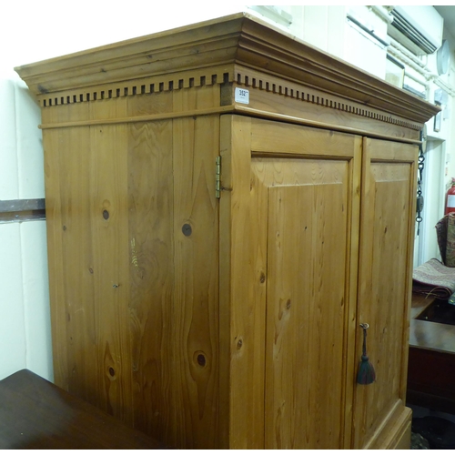 352 - A modern pine linen press with a cornice, over two doors, two short/two long drawers, raised on brac... 