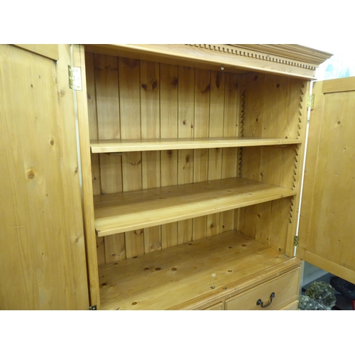 352 - A modern pine linen press with a cornice, over two doors, two short/two long drawers, raised on brac... 