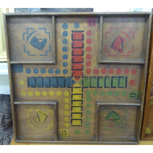 353 - Two painted wooden Parcheesi boards, decorated with equestrian motifs  largest 21.25