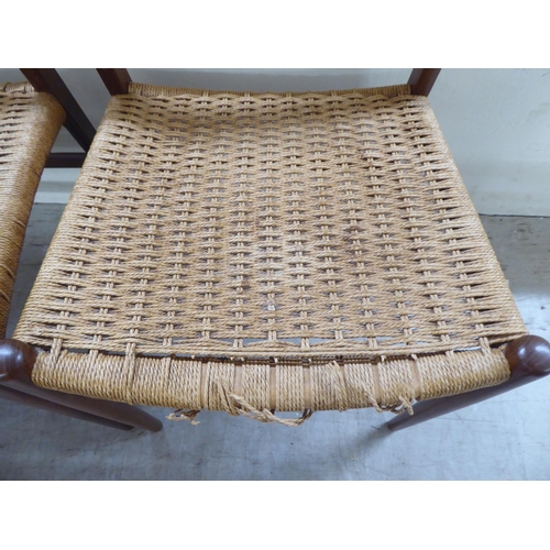 36 - A set of six 1970s teak framed panelled back dining chairs, the woven cane seats raised on turned le... 