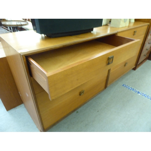 369 - A pair of G-Plan teak graduated, four drawer dressing chests, on plinths  28