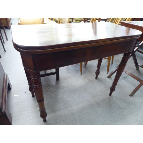 371 - A late Victorian mahogany card table, the foldover top raised on ring turned legs  30