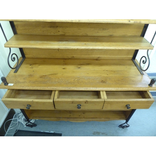 372 - A modern oak and wrought iron mounted dresser with an arrangement of staggered open shelves  76... 