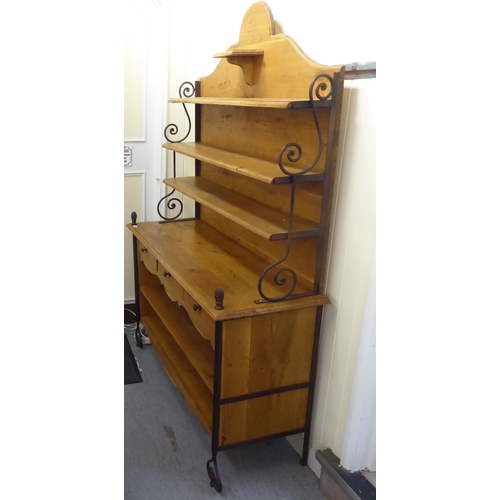 372 - A modern oak and wrought iron mounted dresser with an arrangement of staggered open shelves  76... 