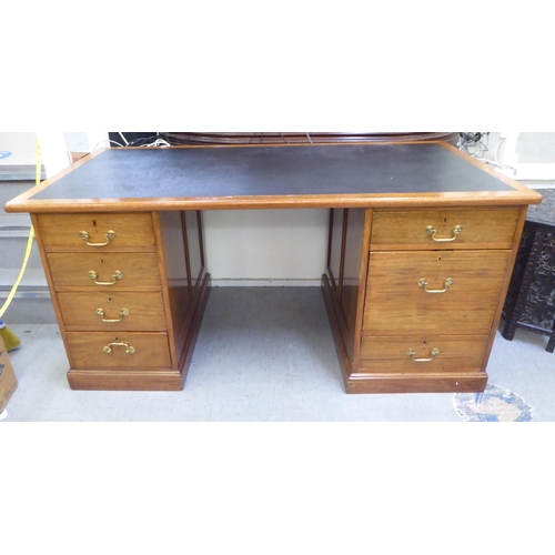 375 - A late Victorian mahogany seven drawer, twin pedestal desk, on a plinth  30