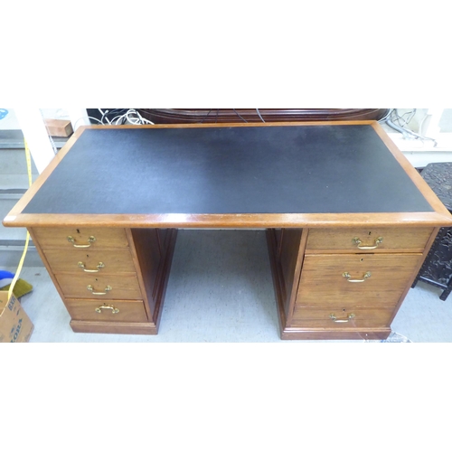 375 - A late Victorian mahogany seven drawer, twin pedestal desk, on a plinth  30