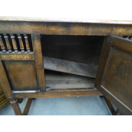 382 - Three items of 20thC Old English style oak furniture: to include a one piece, partially glazed corne... 