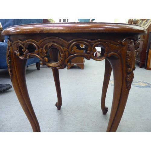 61 - A modern mahogany finished occasional table with a carved frieze, raised on cabriole legs and knuckl... 