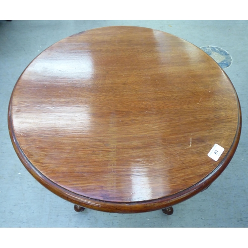 61 - A modern mahogany finished occasional table with a carved frieze, raised on cabriole legs and knuckl... 