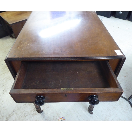 77 - A late 19thC mahogany Pembroke table, raised on turned legs and casters  28