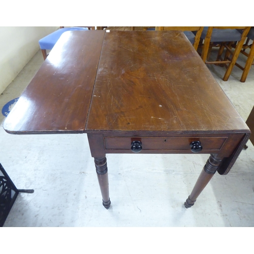 77 - A late 19thC mahogany Pembroke table, raised on turned legs and casters  28