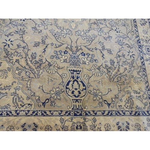 132 - A Persian design carpet, decorated with stylised flora and other designs, on a beige coloured backgr... 