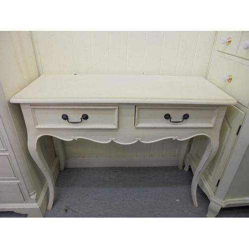 143 - Three items of modern cream painted bedroom furniture, viz. a Laura Ashley cupboard  43