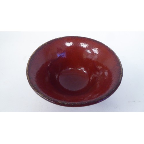 93 - A modern china drip glazed oxblood coloured pottery bowl with a flared rim  7