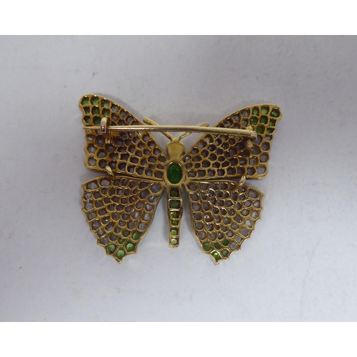 115 - A bi-coloured gold, diamond encrusted and coloured stone set brooch, fashioned as a butterfly