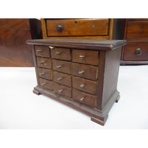 134 - Wooden collectables: to include an early 20thC mahogany miniature four drawer dressing chest  8... 