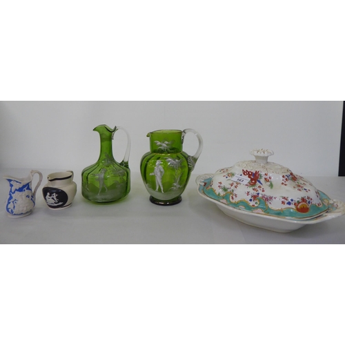 163 - A mixed lot: to include two Mary Gregory style, clear and green glass jugs