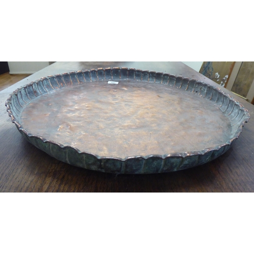 167 - A rustically made Indian copper tray with a crimped border  21.5