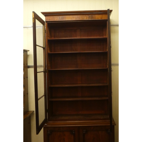 170 - A late Victorian mahogany cabinet bookcase with a straight cornice, over a pair of full-height, carv... 