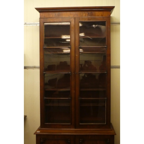 170 - A late Victorian mahogany cabinet bookcase with a straight cornice, over a pair of full-height, carv... 