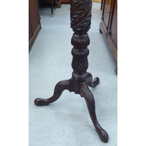 184 - A Victorian style mahogany torchere with a turned plate top, over a wrythen carved column, raised on... 