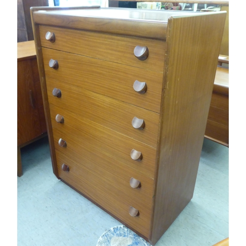 185 - A 1970s teak tallboy, comprising six graduated long drawers with grab handles  42