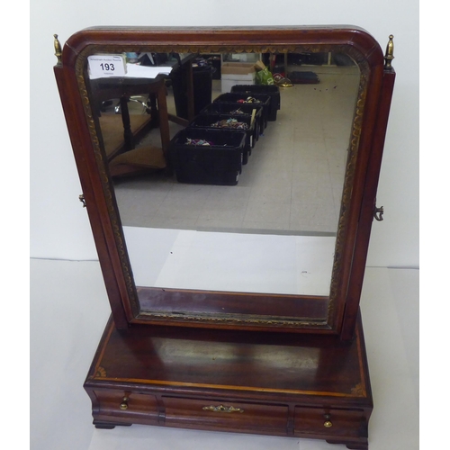 193 - A Georgian carved parcel gilt and mahogany toilet mirror, the plate pivoting on angled horns and a t... 