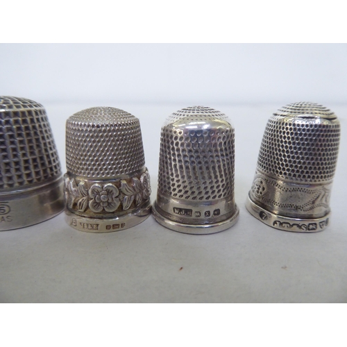 195 - A silver combination reel and thimble case; and various silver/white metal and other thimbles 