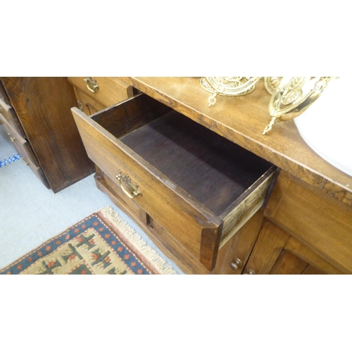 196 - A modern traditional style oak two part dresser, the superstructure with three open fixed shelves, o... 