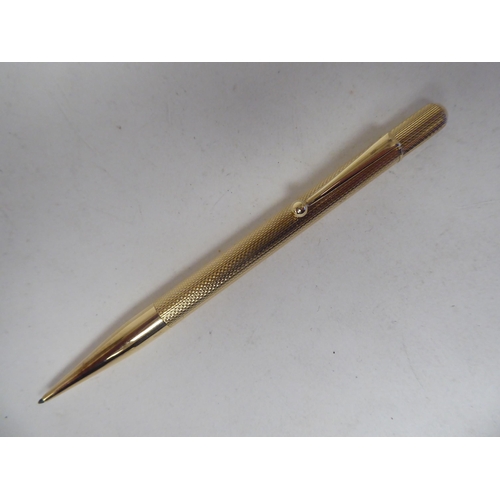 2 - A 9ct gold propelling pencil with engine turned decoration