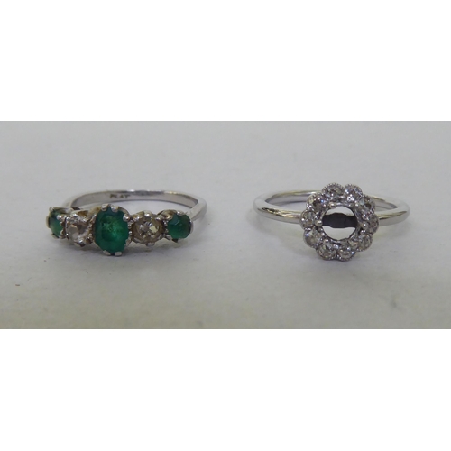 204 - A platinum ring, set with alternating diamonds and emeralds; and another white metal floral design d... 