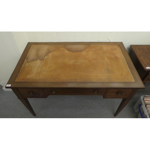 205 - An Edwardian string inlaid mahogany three drawer desk, raised on square, tapered legs  30