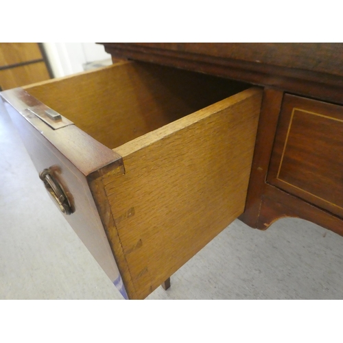 205 - An Edwardian string inlaid mahogany three drawer desk, raised on square, tapered legs  30