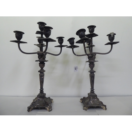 208 - A pair of early 20thC silver plated, five branch candelabra, each on a pedestal base  19