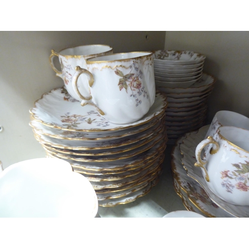 214 - A late 19thC French porcelain tea set, decorated with flora