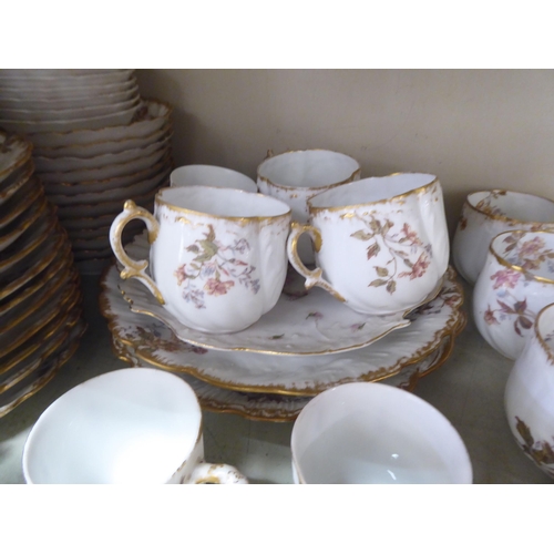 214 - A late 19thC French porcelain tea set, decorated with flora