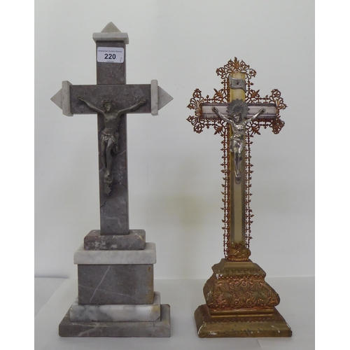 220 - Two freestanding crucifixes, one a cast metal example, decorated with floral patterns  16.5