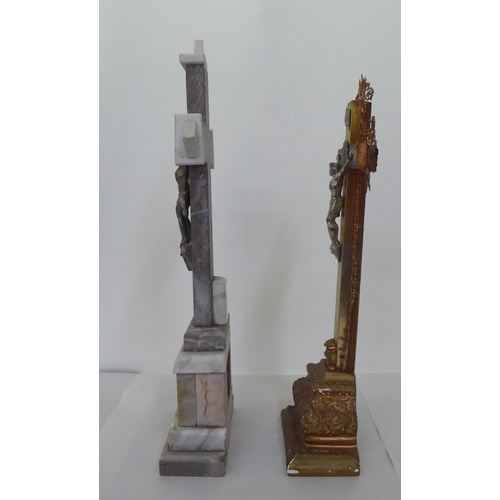 220 - Two freestanding crucifixes, one a cast metal example, decorated with floral patterns  16.5