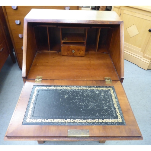 222 - A lady's modern yewwood finished and string inlaid bow front desk, the fall flap with a scriber and ... 