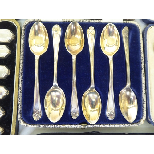 228 - Cased silver presentation spoons: to include a set of six gilded and coloured enamelled coffee spoon... 