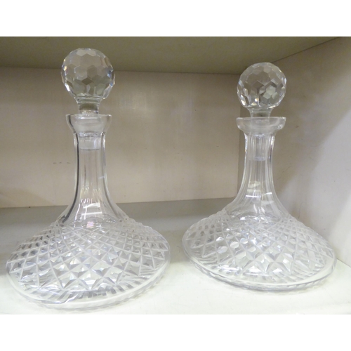 233 - A pair of diamond cut crystal ships' decanters and stoppers