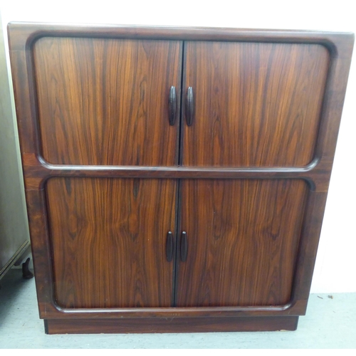 236 - A mid 20thC, possibly Dyrlund, rosewood finished media cabinet, comprising an arrangement of retract... 