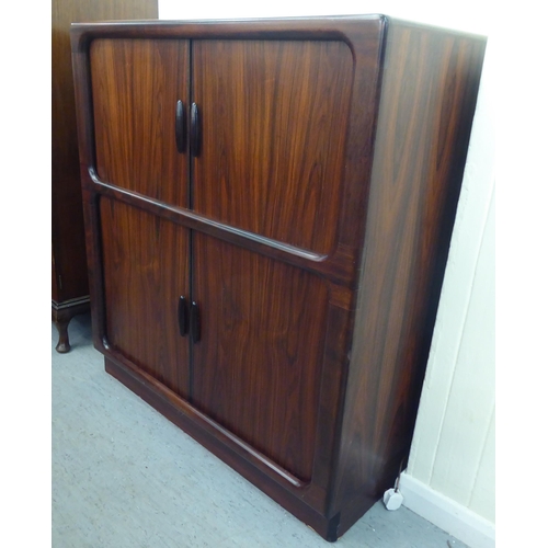 236 - A mid 20thC, possibly Dyrlund, rosewood finished media cabinet, comprising an arrangement of retract... 