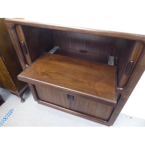 236 - A mid 20thC, possibly Dyrlund, rosewood finished media cabinet, comprising an arrangement of retract... 